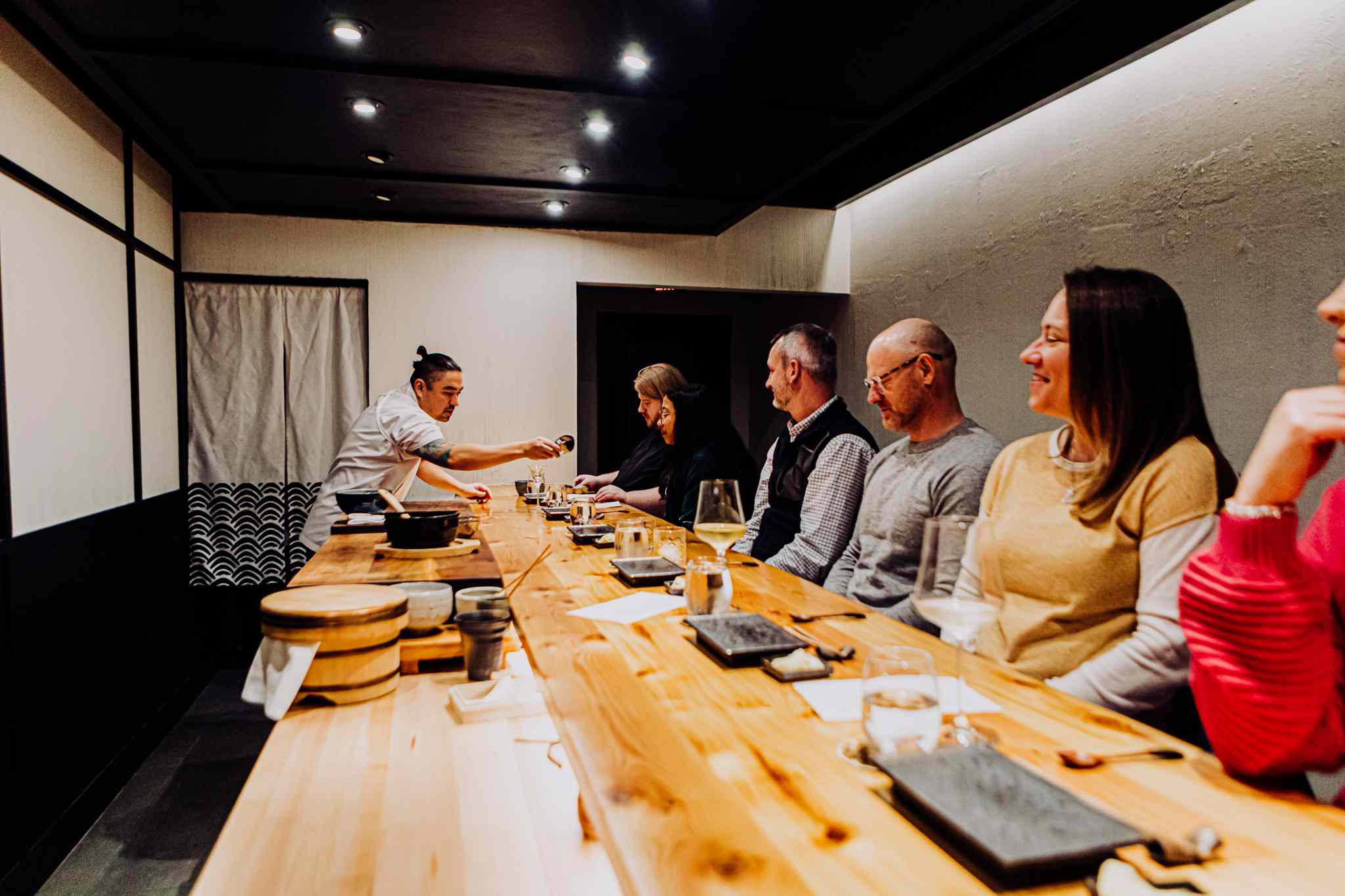 Yoshitomo and Ota owner Dave Utterback serving nigiri for guests at Ota during his Omakase in Omaha, Nebraska on November 28, 2023.